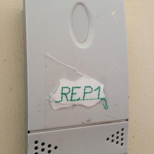 This device has a hand-stitched label taped onto it.