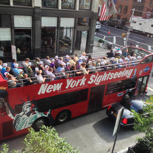 A sightseeing bus filled with Amish-looking folk.