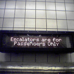 Who else would be on a subway station escalator?